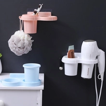 Wall-mounted plastic bathroom organizers in pink white and blue for hair dryers and tools