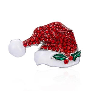 Detailed view of Christmas hat brooch with red rhinestones and white enamel detailing