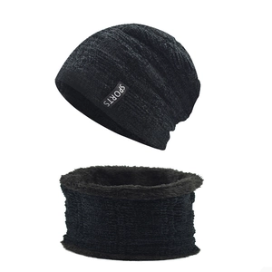 Close-up of black knit winter beanie and scarf set with warm fleece lining and sports label