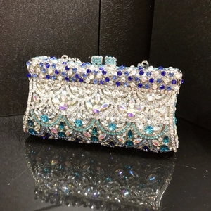 Macro detail of luxury evening clutch with blue and silver rhinestones and retro floral patterns