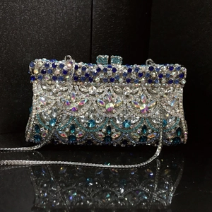 Elegant silver and blue crystal evening clutch with fish scale pattern on mirror background