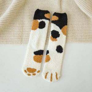Detailed view of plush coral fleece cat claw socks with soft tricolor spot patterns