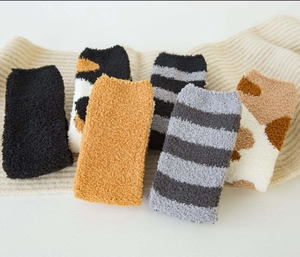 Detailed view of plush coral fleece winter socks in various patterns and warm colors