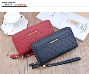 Close-up of dual-zipper long wallets in red and black with elegant quilted pattern