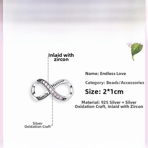 Macro shot of 925 silver infinity charm with pink stones and family forever engraving