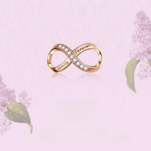 Detail of rose gold S925 silver infinity charm with family forever engraving and zircons