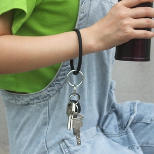 Black silicone O-ring bracelet keychain with silver metal spring clasp and key rings