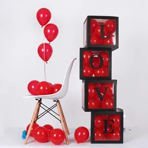 Detailed view of four black transparent party boxes with LOVE letters and red balloons