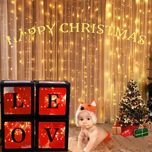 Transparent LOVE boxes with red balloons and LED lights for cozy Christmas party decor