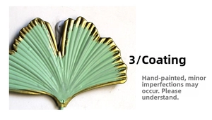 Macro detail of ginkgo leaf wall hook with green paint and golden hand-painted edges