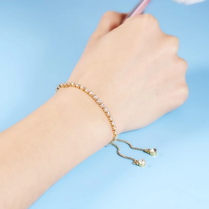 Detail of adjustable gold tennis bracelet with 3mm clear cubic zirconia stones