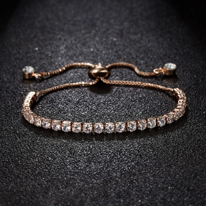 Detail of 3mm rose gold slider bracelet featuring cubic zirconia stones on black background