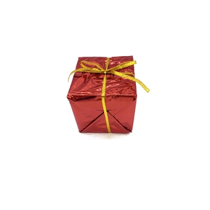 Detailed view of a red shiny foam gift box with golden ribbon for Christmas tree decoration