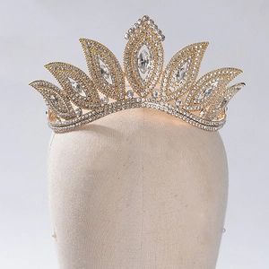 Detailed view of Baroque gold crown with sparkling rhinestones on a mannequin head