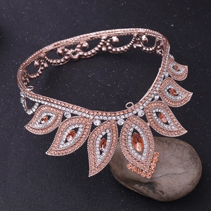 Macro detail of rose gold baroque crown with amber crystals and clear rhinestones