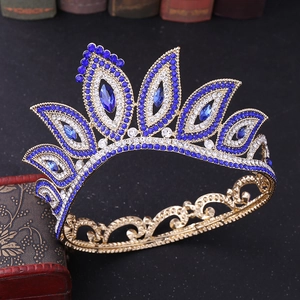 Detail of baroque bridal crown with blue teardrop rhinestones on golden metal base