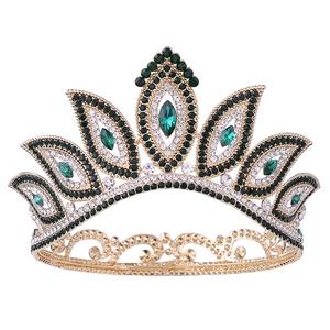 Detailed macro of gold bridal crown with intricate green crystals and leaf patterns