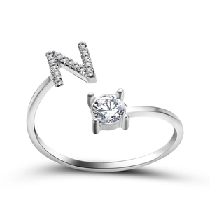 Macro detail of silver adjustable ring with letter N and sparkling zircon setting