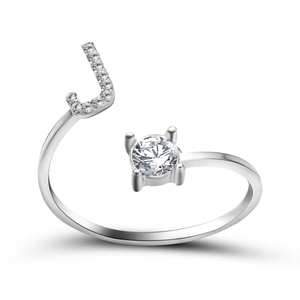 Detail of adjustable ring featuring a pavé-set letter J and a sparkling round solitaire stone
