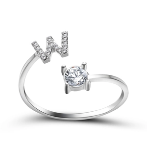 Detail of adjustable silver ring with sparkling crystal letter W and round solitaire stone