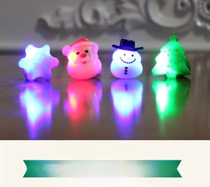 Close-up of four glowing LED Christmas rings featuring Santa, Snowman, and Tree shapes