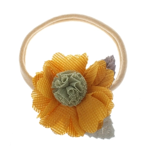 Detail of yellow fabric flower on soft elastic nylon baby headband with mesh petals