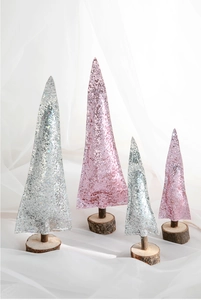 Close-up of pink and silver glitter mini Christmas trees on natural wood bases