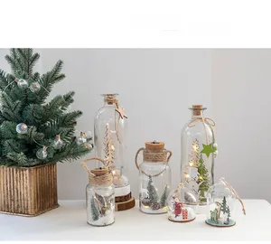 Detail of Nordic Christmas glass bottles with LED lights and miniature snowy scenes