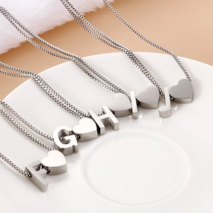 Titanium steel heart initial necklaces with F to J letter pendants on ceramic plate