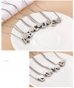 Detail of silver heart letter necklace featuring custom A-E pendants and LOVE spelling