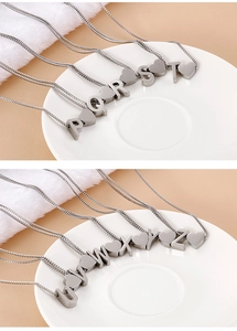 Close-up of silver heart-shaped initial necklaces featuring letters P to Z on fine chains