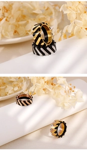 Macro shot of industrial style striped titanium steel rings in multiple color finishes