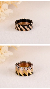 Close-up of wide industrial titanium rings with mechanical interlocking diamond pattern