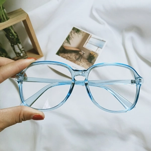 Retro transparent blue eyewear frame with 7138 model specifications in a hand-held view