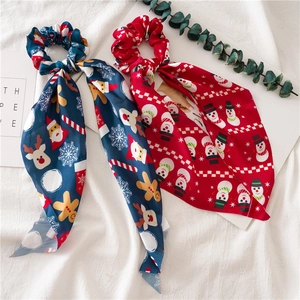 Detail view of navy blue and red Christmas scrunchies with festive ribbons and patterns