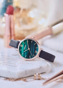 Detail of elegant ladies' watch with malachite green dial and rose gold case