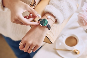 Detail of vintage green malachite dial watch with rose gold case and black leather strap