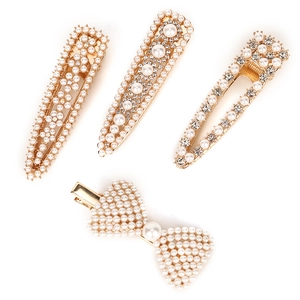 Elegant 4-piece set of gold hair clips with white pearls, crystals and bow design