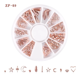 Macro view of rose gold moon star nail charms in a 12-compartment storage case