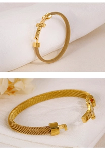 Close-up of golden stainless steel mesh woven bracelet with geometric T-shaped clasp detail