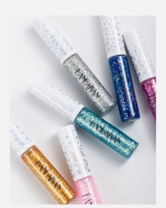 Macro shot of colorful glitter liquid eyeliner set with sparkling white caps