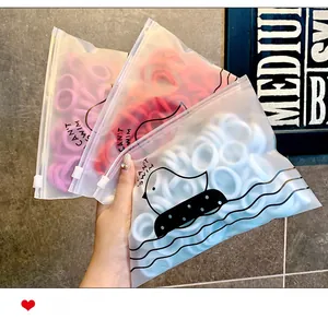 Set di tre confezioni di elastici per capelli colorati in sacchetti con paperelle