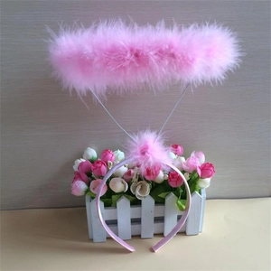Detailed view of a pink feather angel halo headband for festive party costumes