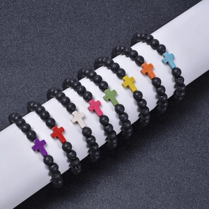 Set of 8 lava rock bracelets with colorful alloy cross pendants on a display stand