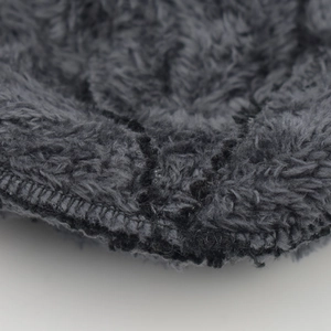 Macro detail of thick fleece lining and durable stitching on knitted winter hat set