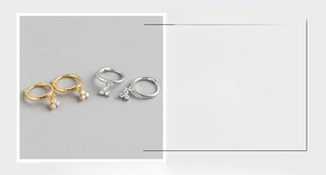 Macro view of S925 sterling silver hoop earrings with three zircon triangle charms