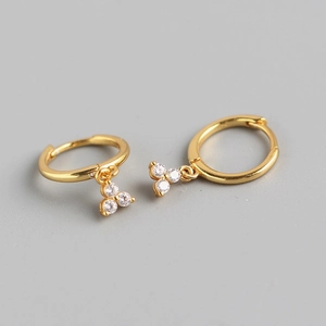 Detail of gold S925 sterling silver hoop earrings with three sparkling clear crystals