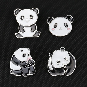 Set of four cute panda enamel pins with various poses on a textured black background