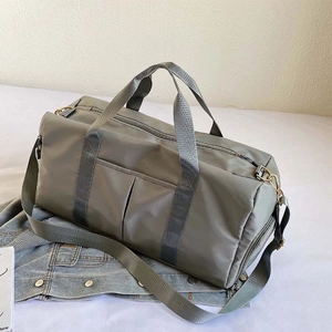 Detail of grey-green yoga gym bag with shoe compartment and detachable shoulder strap