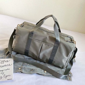 Detailed close-up of a durable nylon travel bag with reinforced straps and multi-pocket design